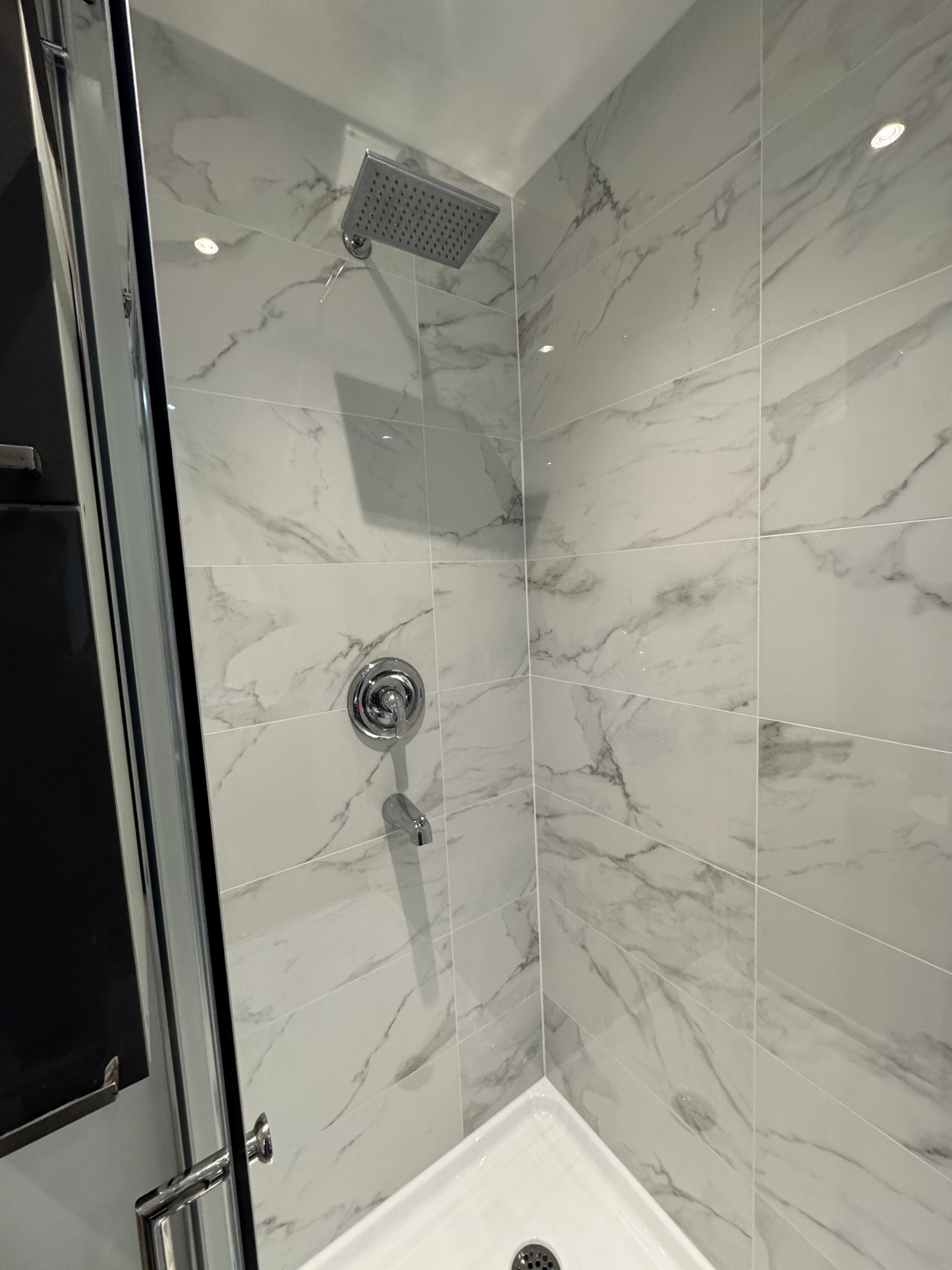 Custom walk-in shower with large format faux marble porcelain tile