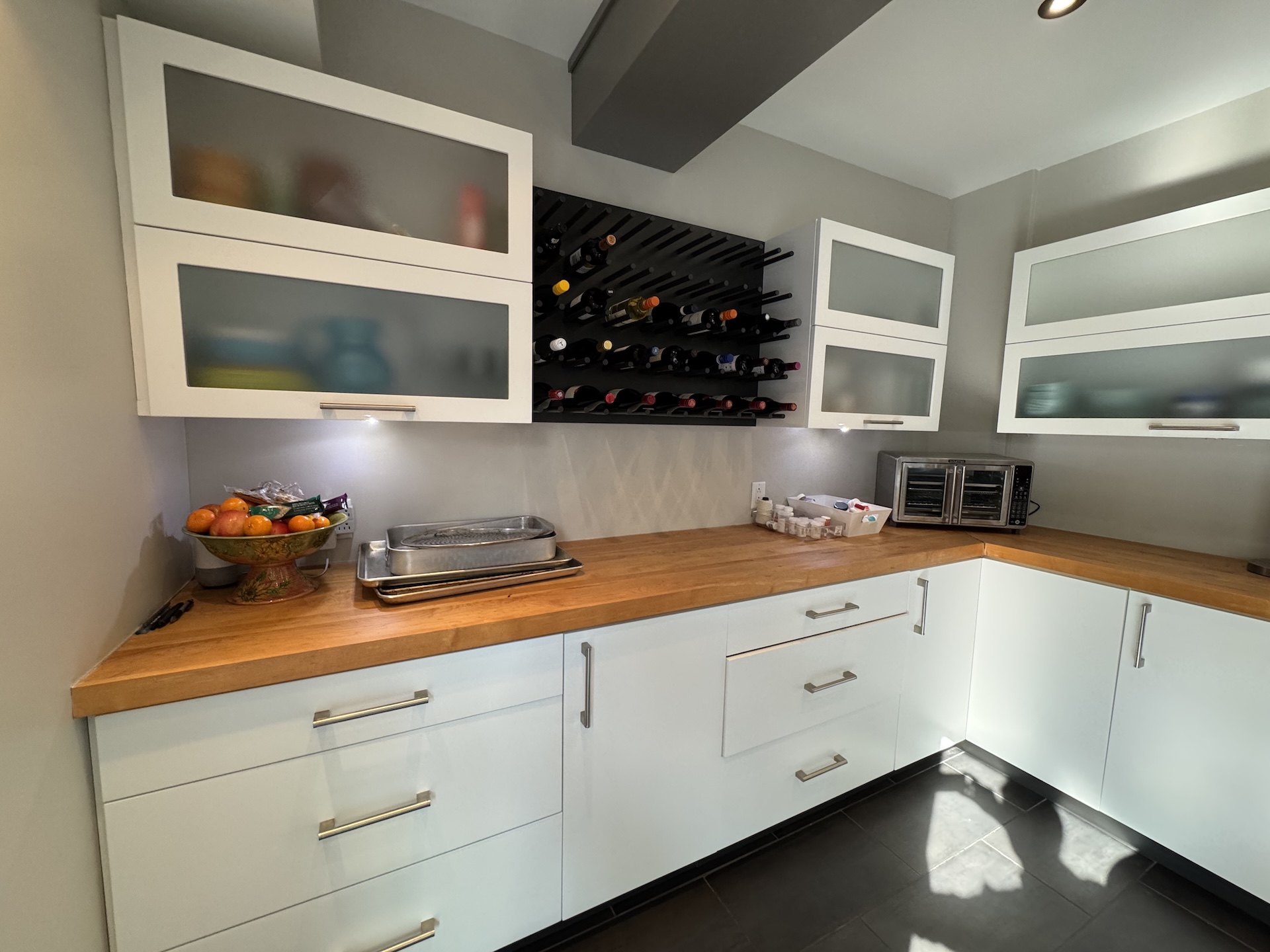 Custom wine rack and butcher block countertop detail in modern kitchen