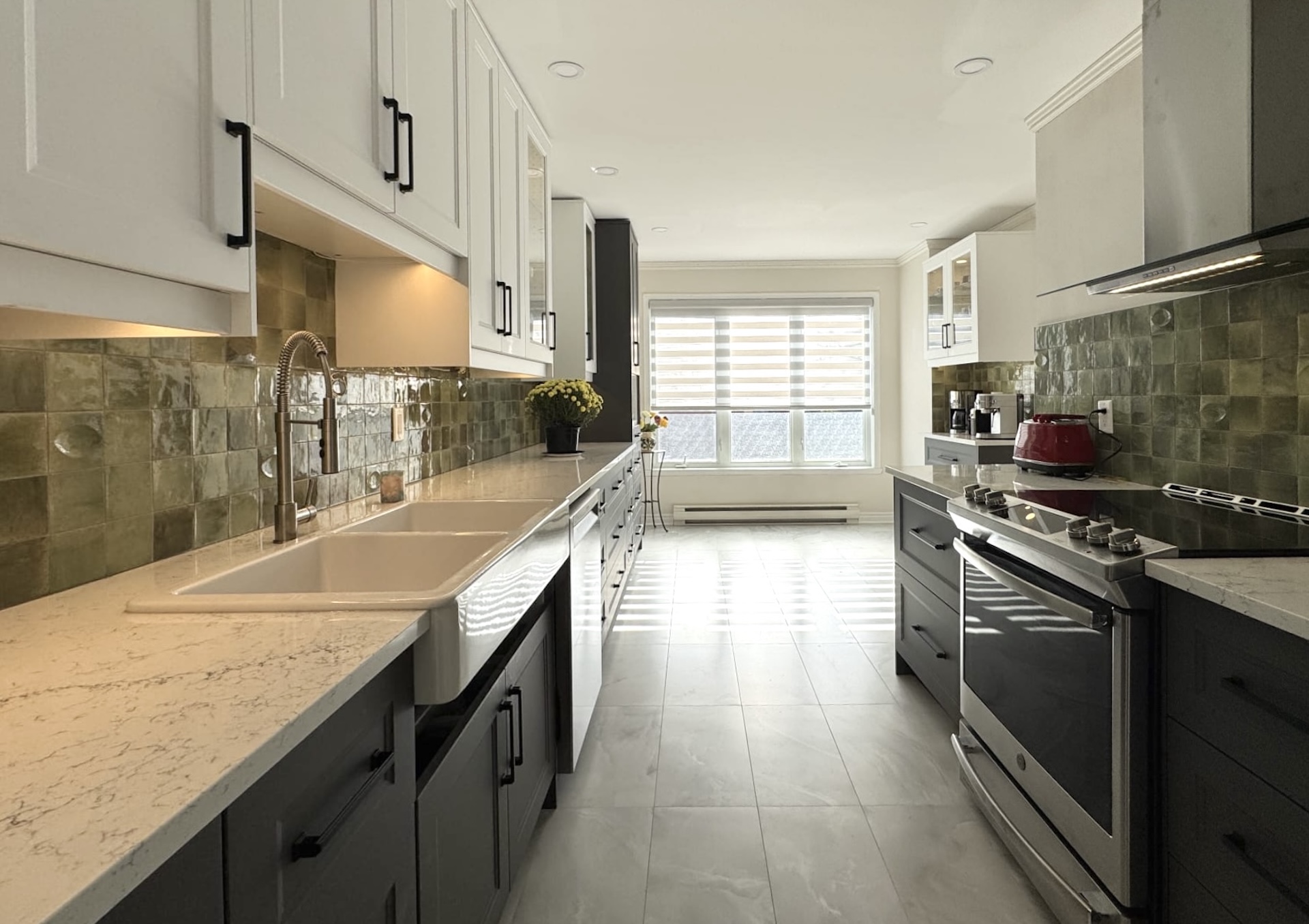 Galley style kitchen layout featuring artisan green tile backsplash and large window