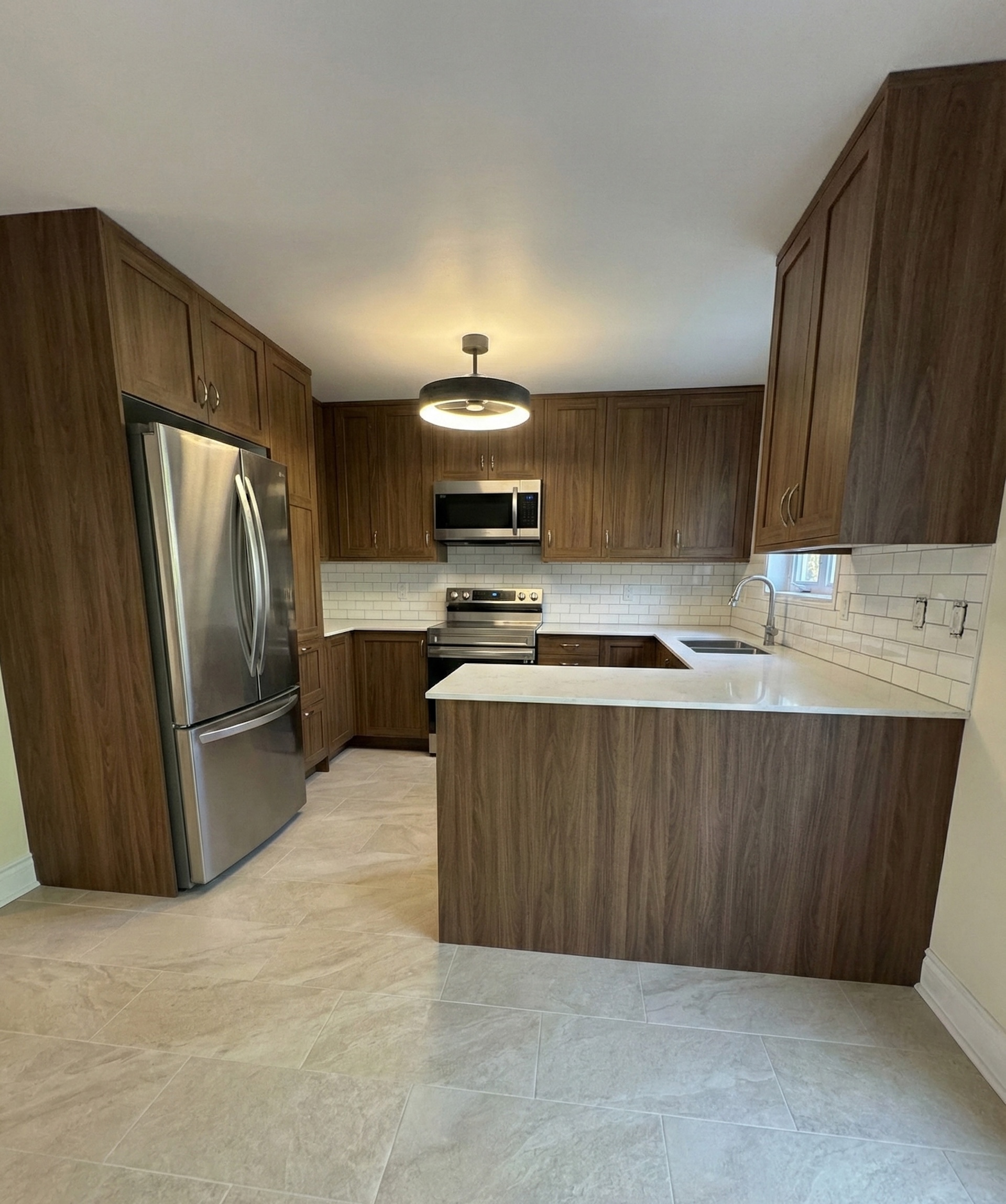 Modern U-shaped kitchen remodel with warm wood flat-panel cabinets